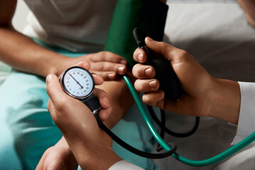 doctor measures blood pressure of a patient close up
