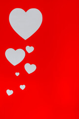 White hearts on red background with copy space. Design for St. Valentine's day.