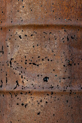 old rusty barrel with holes