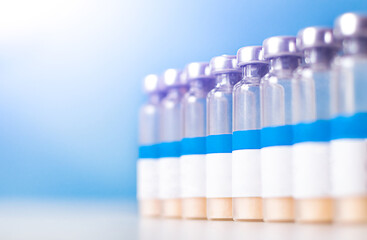Vaccine injection bottles with white label in a row and copy space