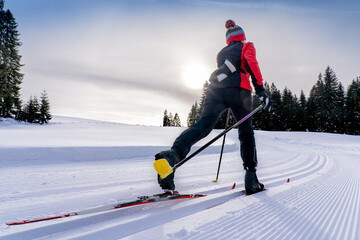 beautiful active senior woman cross-country skiing in fresh fallen powder snow in the Allgau alps near Immenstadt, Bavaria, 