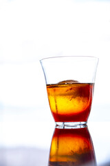 Iced Americano coffee in glass cup on glass table with outdoor background
