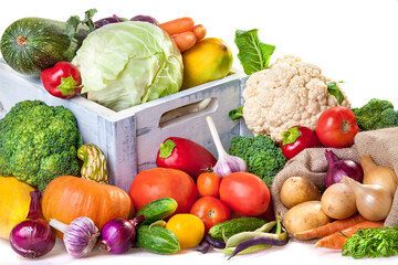 Fresh vegetables at your table. An assortment of organic vegetables: cucumbers, tomatoes, broccoli, cabbage, peppers, kohlrabi, onions, garlic, zucchini, potatoes, carrots and pumpkin.