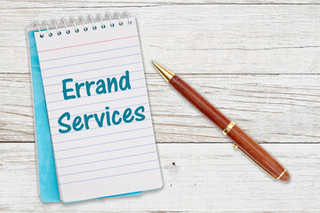 Errand Services message on retro lined paper notepad on a weathered wood desk
