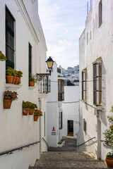 stairs leading down through a narrow alley in the historic city center of Vejer de la Frontera