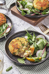 Smoked mackerel fishcakes served with a rocket, spinach salad