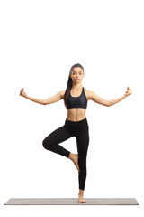 Full length portrait of a young female in a yoga pose on an exercise mat