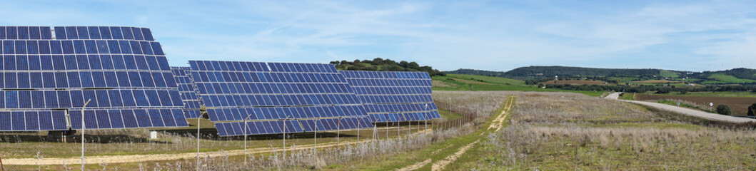 panorama view of many large solar energy panels in the countryside of Andalusia