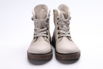 Beige winter boots with fur on white background