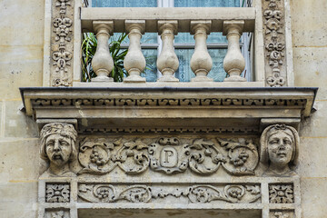 Fototapeta premium Traditional French house with typical balconies and windows. Paris, France.