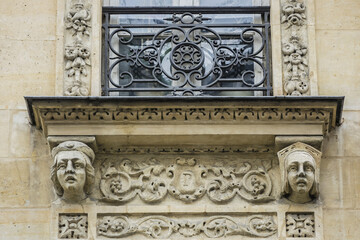 Traditional French house with typical balconies and windows. Paris, France.