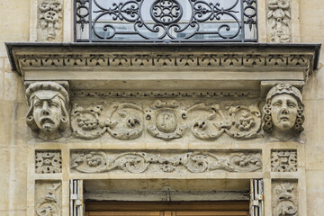 Traditional French house with typical balconies and windows. Paris, France.
