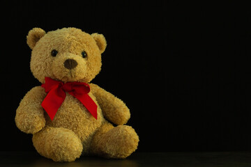 
soft toy brown teddy bear with a red bow