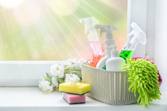 Spring Cleaning Concept - Cleaning Supplies And Flowers On Blur Background, Copy Space