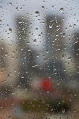 Water drops on the glass on rainy city day