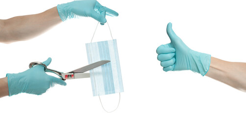 medical mask in hands in a blue disposable blue medical glove cut with scissors a blue mask on a white background. The concept of the end of the coronavirus. Covid-19.