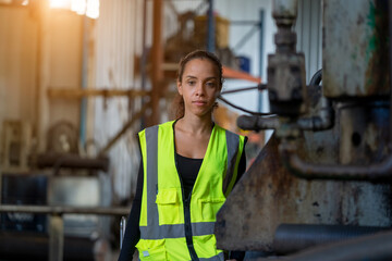 Portrait of industrial woman engineer working in a factory.