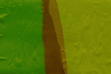 Green torn paper collage close-up. Texture made from various paper and cardboard parts. Damaged old paper background. Vintage blank wallpaper. Material design backdrop.