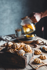 Man pours Hot tea with slices of fresh grapefruit on wooden tablet. Healthy drink, Eco, vegan.