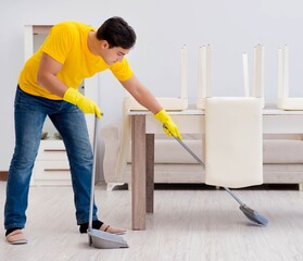 Man cleaning the house helping his wife