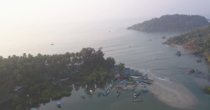 Wooden Boats Moored At Seashore With Thicket Coconut Palm Trees At Palolem Beach, Canacona, South Goa, India. - Aerial Drone Shot