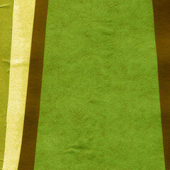 Green torn paper collage close-up. Texture made from various paper and cardboard parts. Damaged old paper background. Vintage blank wallpaper. Material design backdrop.