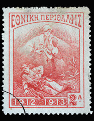 Stamp printed in Greece shows Dying soldier, widow and child, circa 1914