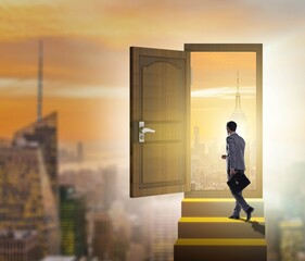 Businessman walking towards open door