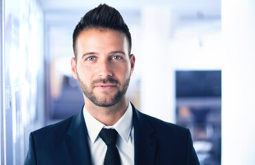 Fototapeta premium Handsome businessman close-up portrait while standing in the office