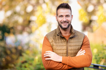 Naklejka na ściany i meble Portrait of handsome man standing outdoor in the autumn weather