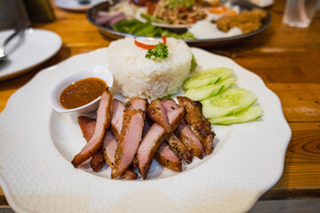 Grilled pork topped over steamed rice with vegetable