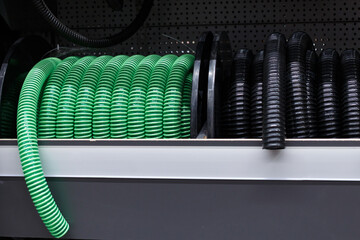 Green and black corrugated hose on a store shelf.