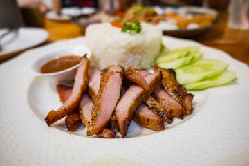 Grilled pork topped over steamed rice with vegetable