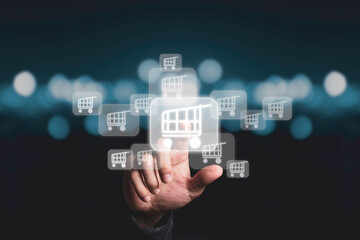 Businessman touching virtual shopping cart trolley with blue bokeh background, Online shopping concept.