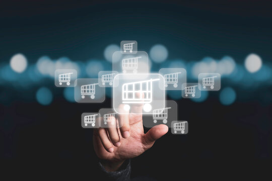 Businessman touching virtual shopping cart trolley with blue bokeh background, Online shopping concept.