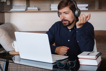 Happy male student online teacher wear headphone talk video calling