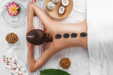 Obraz na płótnie Canvas Woman getting spa hot stones massage