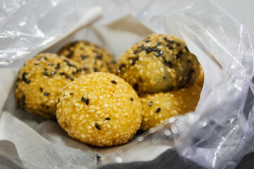 Fried buns sprinkled with sesame seeds into a round shape