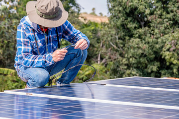 man installing connect power solar panels on a roof house for alternative energy photovoltaic safe energy. power from nature sun power solar cell generator.