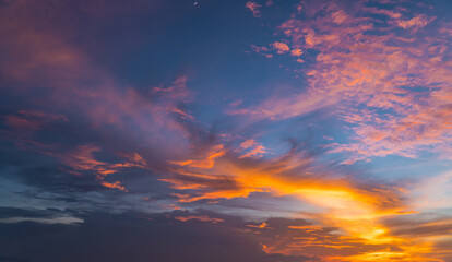 Colorful sunset sky background in the evening with dramatic sunlight clouds on twilight, dusk sky.