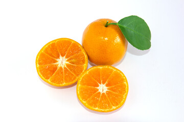 Whole tangerines and tangerines cut in half on a white background.