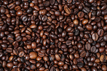 Concept wallpaper for a coffee shop. The scattered coffee beans are combined with a plain background. The texture of the coffee beans is very striking. Template background for mockup design.