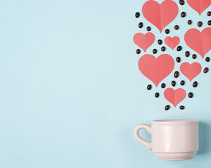Valentine's background concept with coffee lovers. Combination of a white cup with coffee beans and a heart shaped cut of paper. Template design. Let's celebrate Valentine's Day by enjoying coffee.