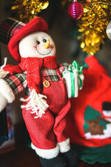 Snowman Santa Claus with gifts under the Christmas tree, happy festival season, happy snowmen with gifts on a christmas tree