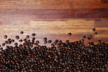 Concept wallpaper for a coffee shop. The scattered coffee beans are combined with a plain background. The texture of the coffee beans is very striking. Template background for mockup design.
