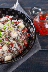 .Brazilian food called Baião de Dois. Very common in the north of the country. Made with rice, beans, sausage and rennet cheese.