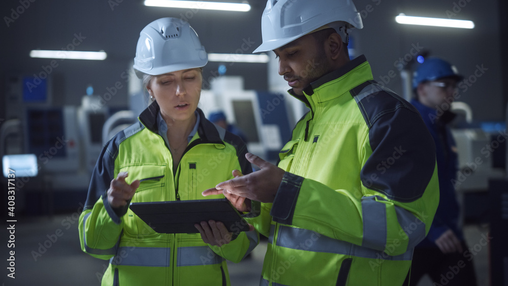 Leinwandbilder chief engineer and project manager wearing safety vests and hard hats, use digital tablet computer i