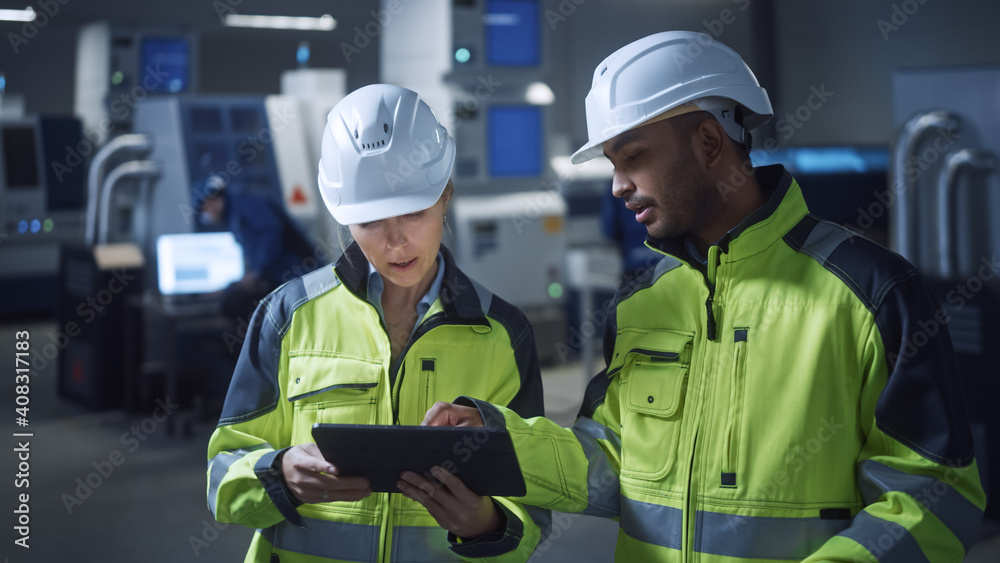 Poster chief engineer and project manager wearing safety vests and hard hats, use digital tablet computer i