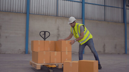Smiling warehouse workers preparing a shipment in a large warehouse