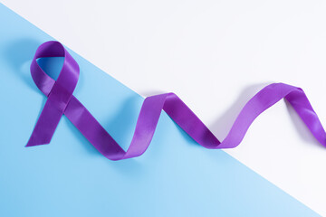 World cancer day, purple ribbon on with and blue background with copy space for text. Healthcare...